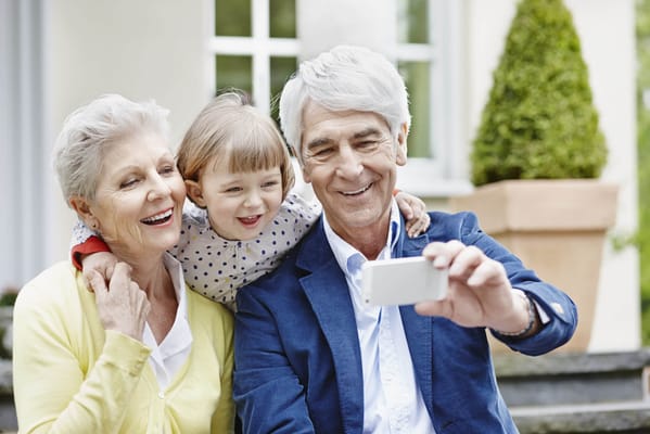 Elderly couple with a child taking a selfie together