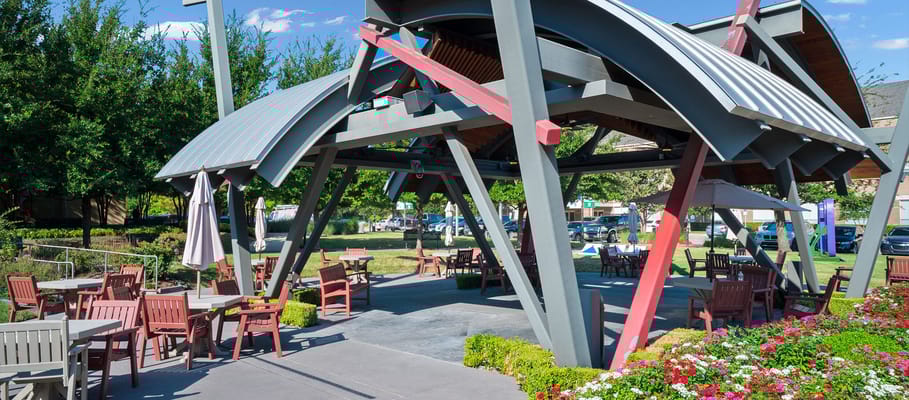 Outdoor pavilion with seating and gardens