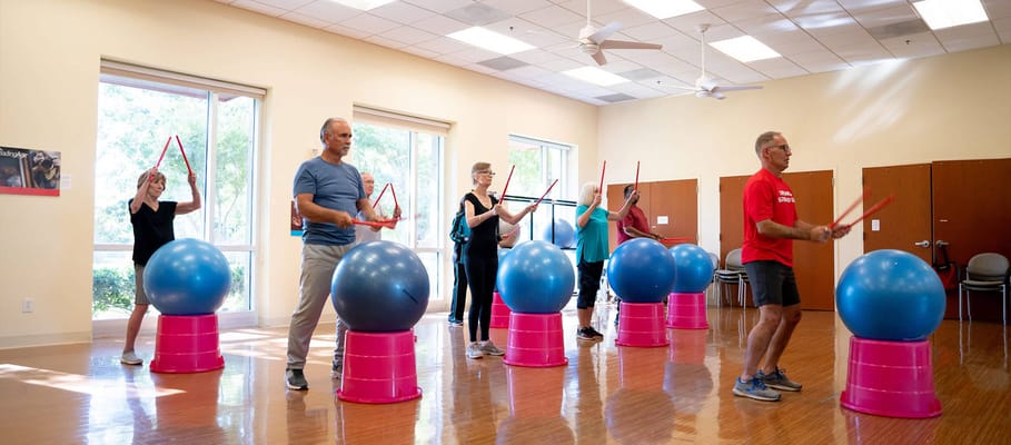 Residents participating in a fitness class with exercise balls
