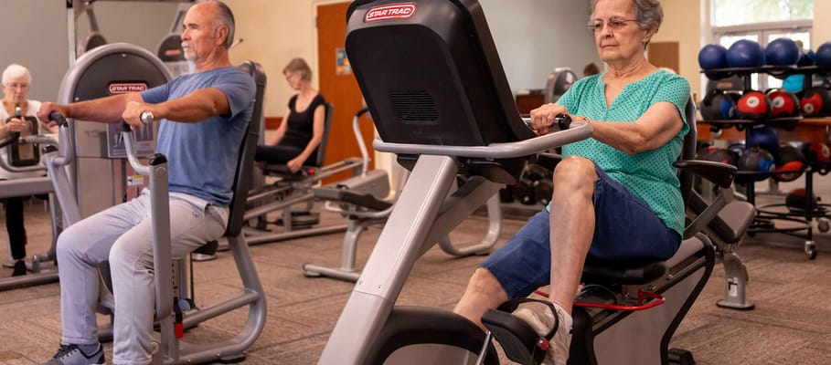 Residents exercising in a fitness center