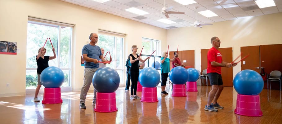 Residents participating in a fitness class with exercise balls