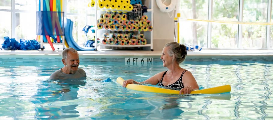Residents enjoying an aquatic exercise session in a pool