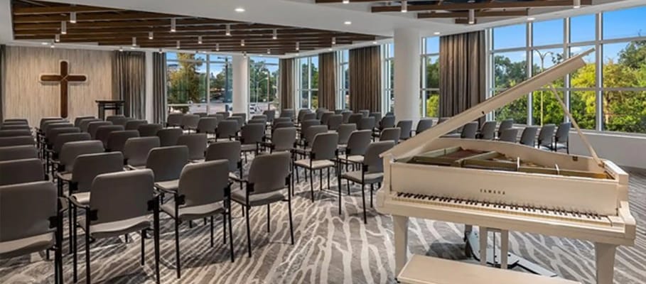 Interior view of a multi-purpose room with piano and seating