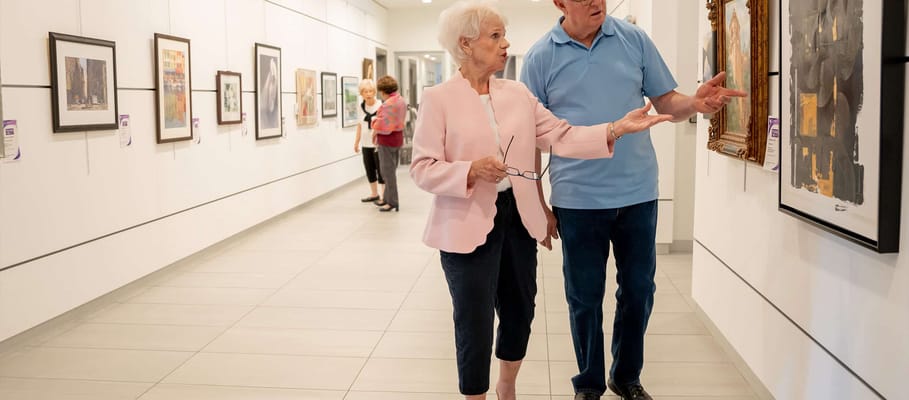 Residents engaging in an art display inside the facility