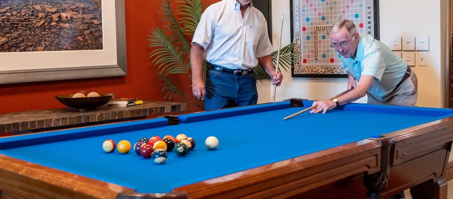 Residents enjoying a game of pool in a common area