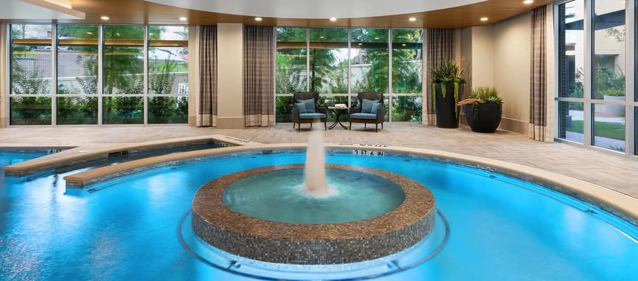 Indoor pool area with fountain and seating