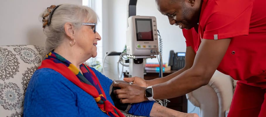 Staff member checking a resident's blood pressure
