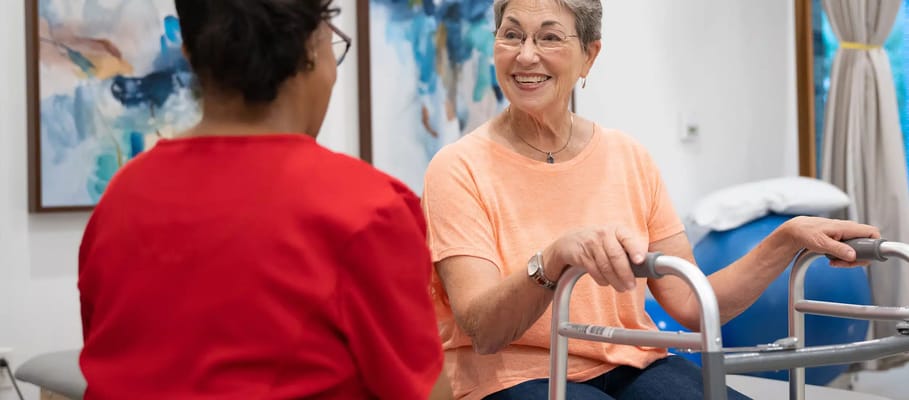 Resident engaging with staff in an activity room