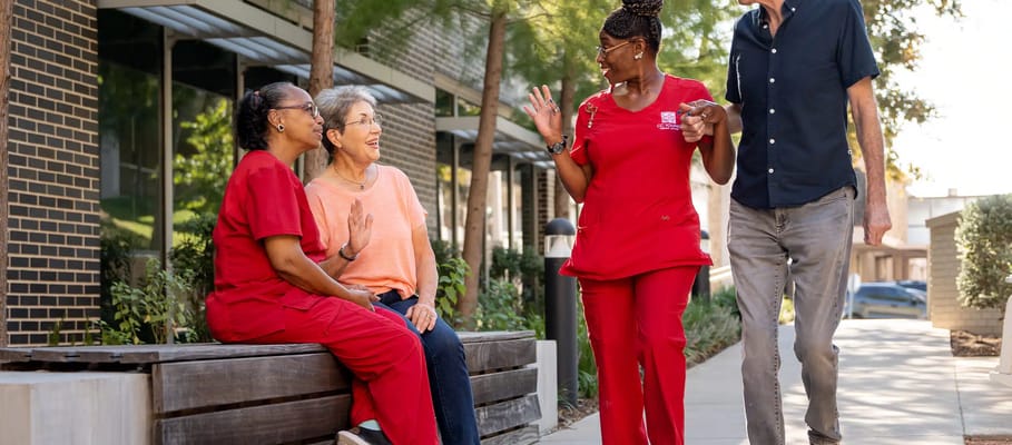 Staff and residents enjoying conversation outside