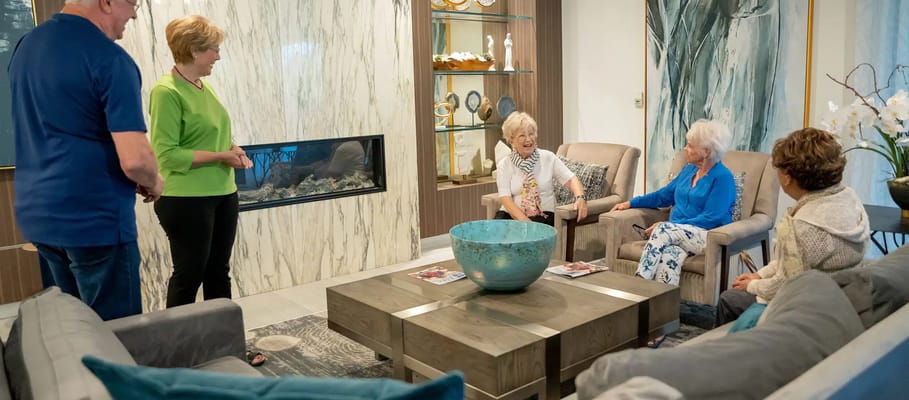Residents enjoying a conversation in a cozy lounge area