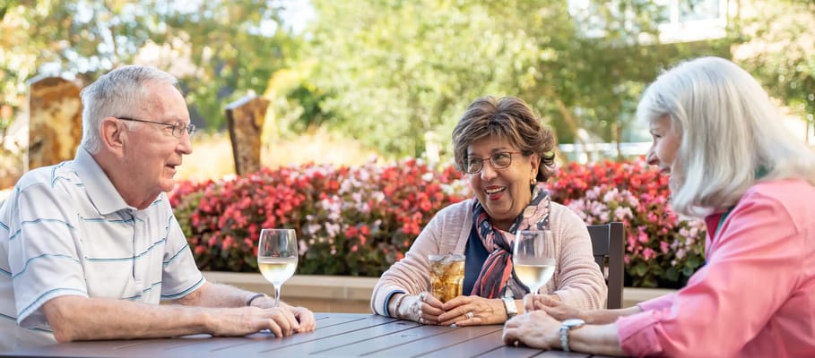 Residents enjoying drinks in a garden area