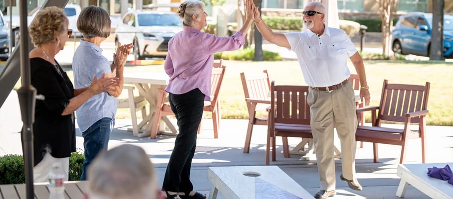 Residents engaged in a celebratory high-five outdoors