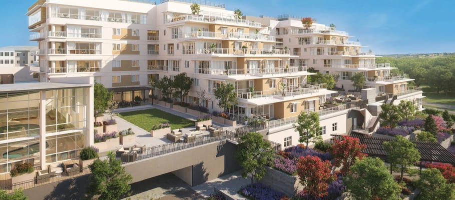 Exterior view of a senior living facility with gardens