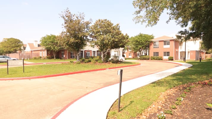 Entrance path with signage at The Gardens of Bellaire
