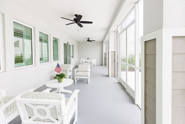 A relaxing outdoor seating area with plants and an American flag