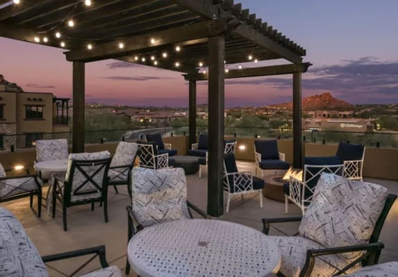 Outdoor seating area with a view at sunset