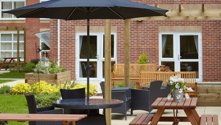 Outdoor seating area with tables and umbrellas