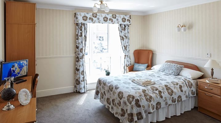 Cozy resident room with bed and window