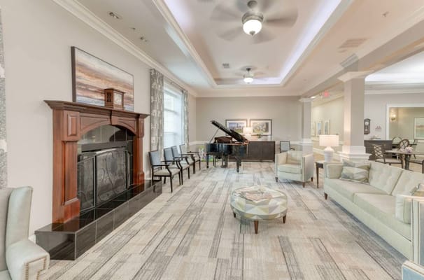 Cozy living room featuring a piano, comfortable seating, and artistic decor