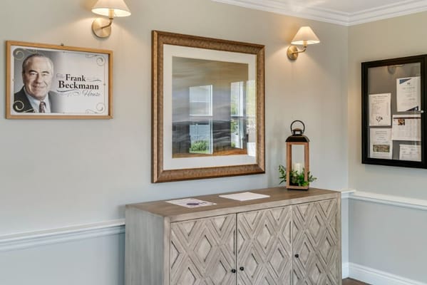 Lobby with framed artwork and a decorative cabinet