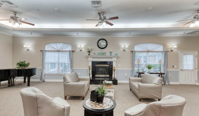 Cozy common area with seating, fireplace, and piano.