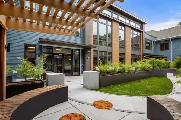 View of the courtyard with seating and greenery at Adelaide of Newton Centre