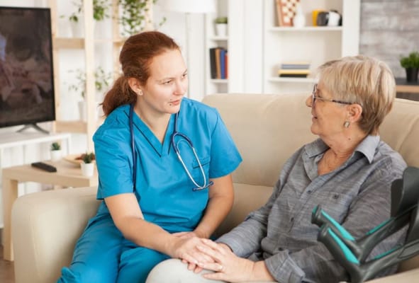 A caregiver talking to a resident in a cozy living room