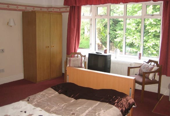 Cozy resident room with a bed and window view