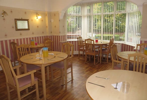Bright dining area with tables set up for residents