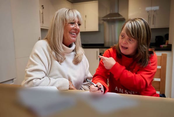 Residents engaged in a friendly conversation in a cozy kitchen