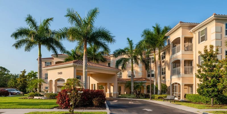 Exterior view of the American House facility with palm trees