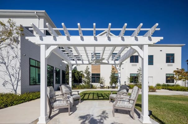 Outdoor seating area with a pergola and landscaping