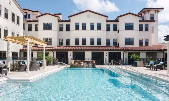 Outdoor pool area with the facility building in the background