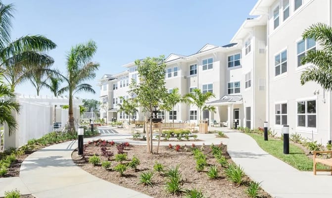 Outdoor courtyard area with landscaping and buildings