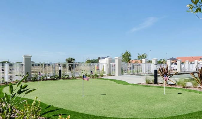 Outdoor putting green area with American flags