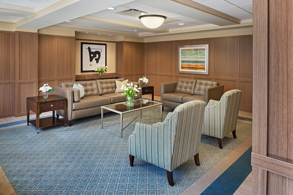 Cozy lounge area with seating and artwork