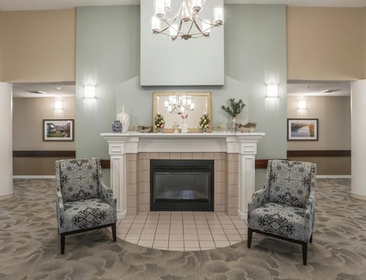 Comfortable common area with chairs and a fireplace