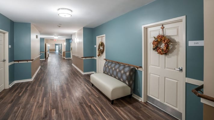 Interior hallway of a senior care facility with decorated doors