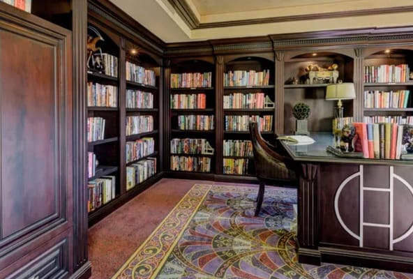 Interior view of a library with bookshelves and a desk
