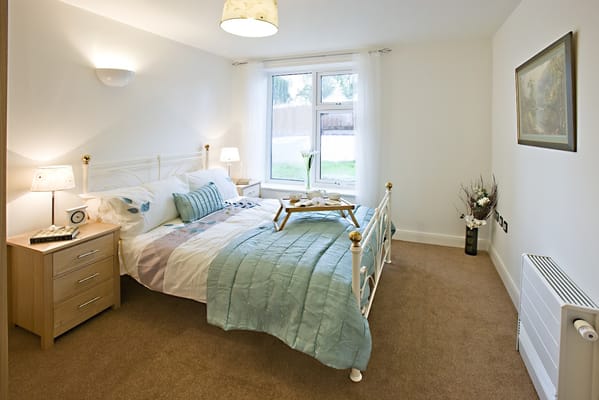 Bright private resident room with a bed and window view