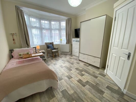 A comfortable private resident room with natural light