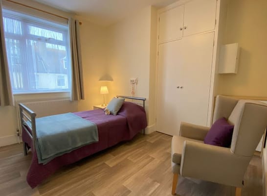 Private resident room with bed and chair