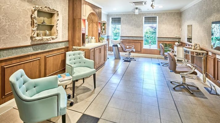 Well-appointed salon area with styling chairs and decor