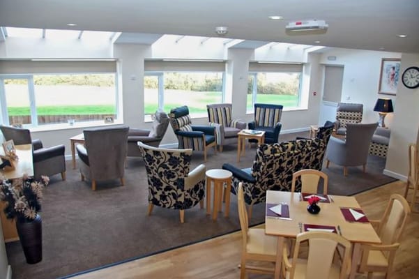 Bright common area with comfortable seating and large windows