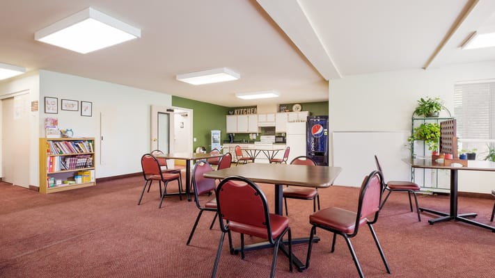 Dining area with tables and chairs in a bright space