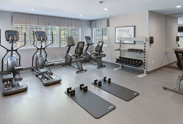Well-equipped fitness room with exercise machines