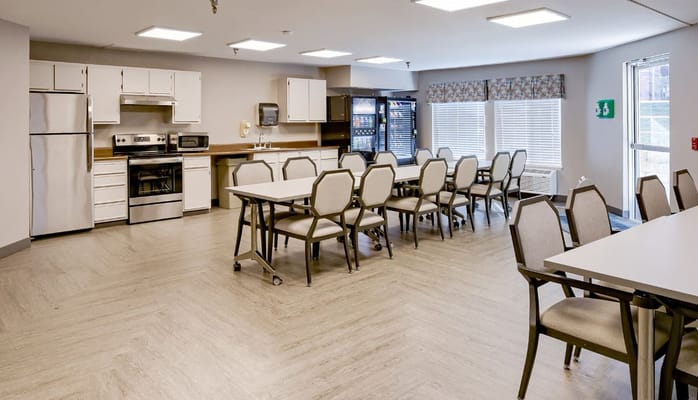 Bright dining area with tables and kitchenette
