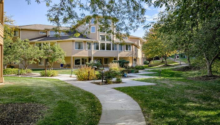 Exterior view of Asher Point Independent Living with gardens