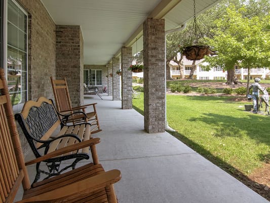 Porch seating area with rockers overlooking the lawn
