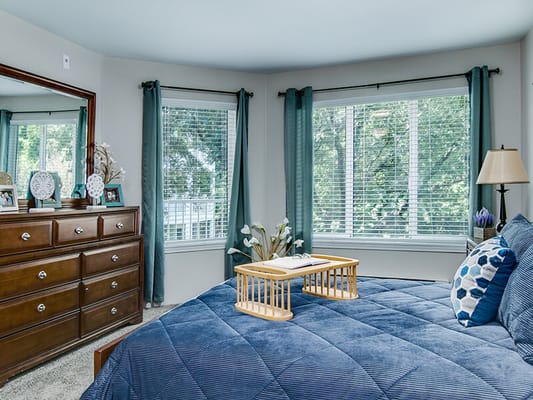 Well-furnished resident bedroom with natural light